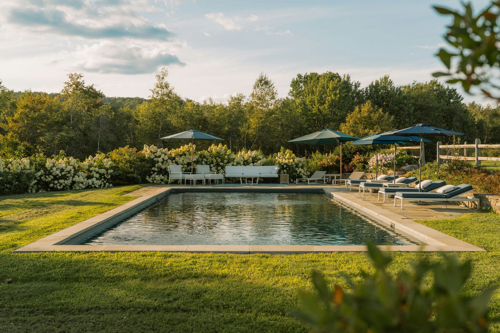 Farmhouse swimming pool with loungers and gardens